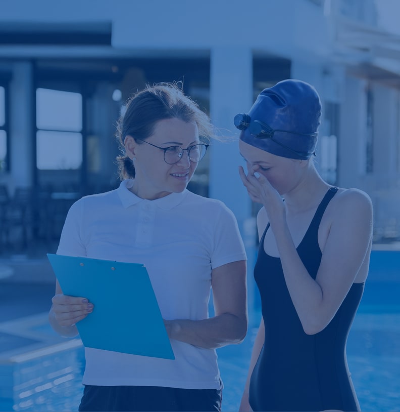 Coach speaking to swimming athlete
